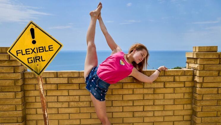 Flexible brunette Nicole Murkovski teases with her wet pussy